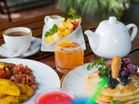 A table full of breakfast favorites.

Fresh fruit, pancakes, tea, and a hearty English breakfast to start the day.